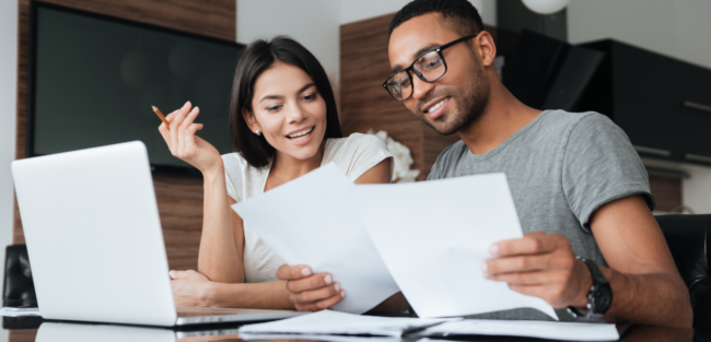 Financial Literacy Month An image of a couple having a discussion with a text: To buy or not to buy in November