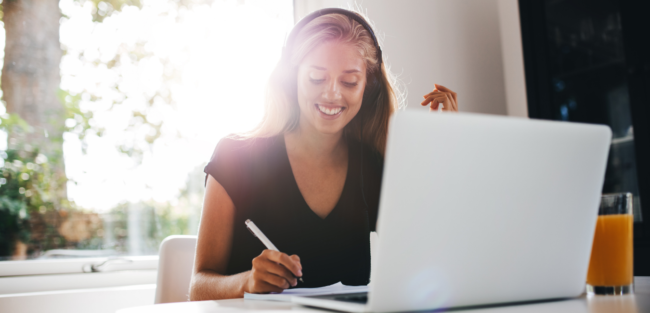 Upgrade your skills a woman studying in front of a laptop while taking notes