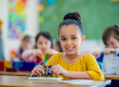 A young child sitting in a classroom