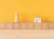 an image with a yellow background and a text "Homesick"