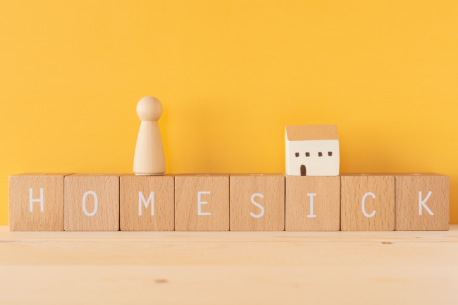 Homesick 1 an image with a yellow background and a text "Homesick"